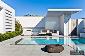 67bf58c68075f_images 3 A pool with an outdoor furniture and seating area.