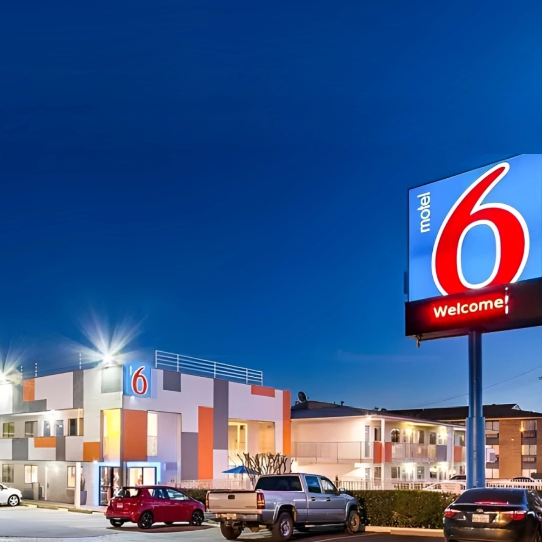 GettyImages-1791708695-scaled-square A motel 6 sign in front of a building.