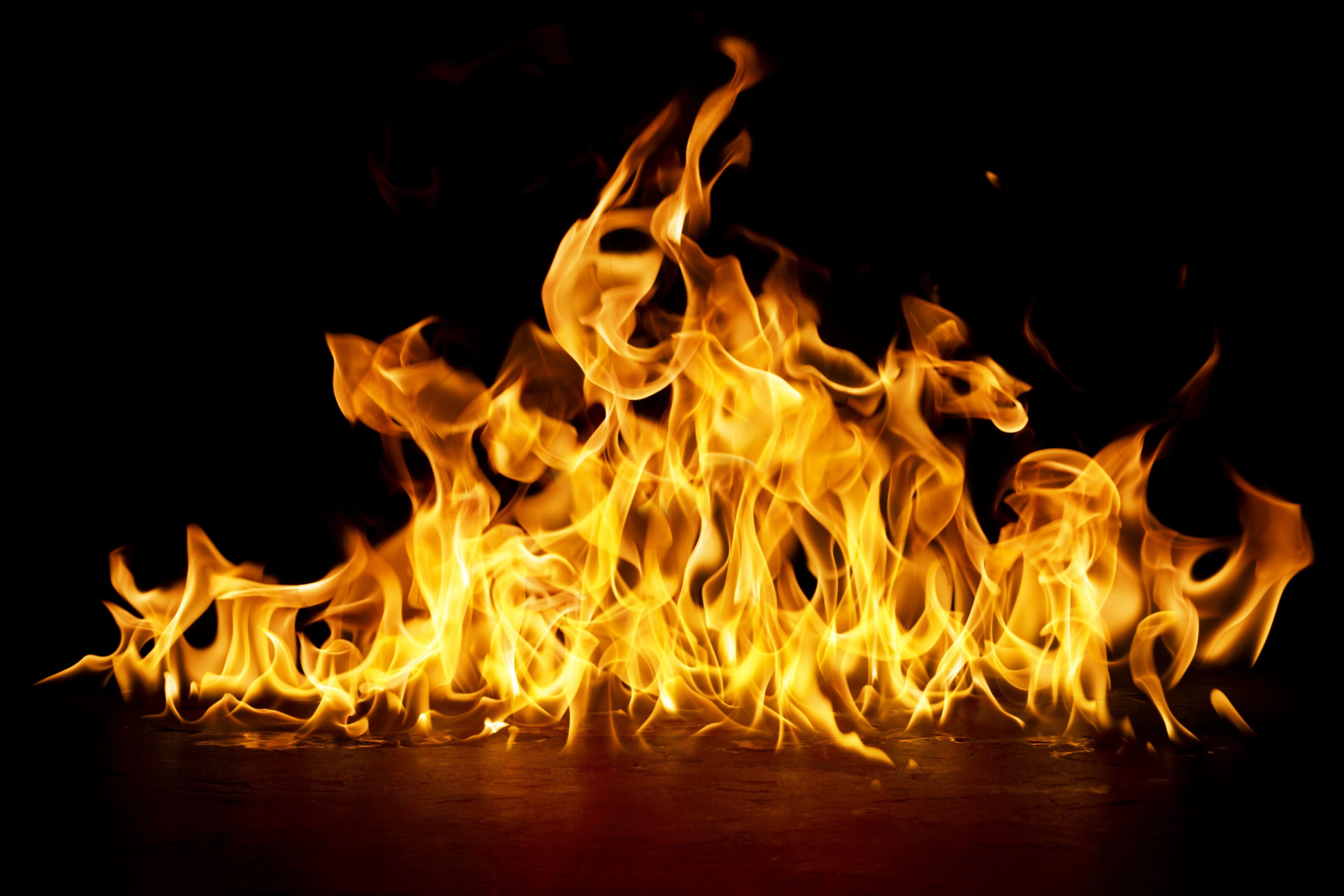 fire png burning flame Isolated on a black background A fire is burning in the dark.